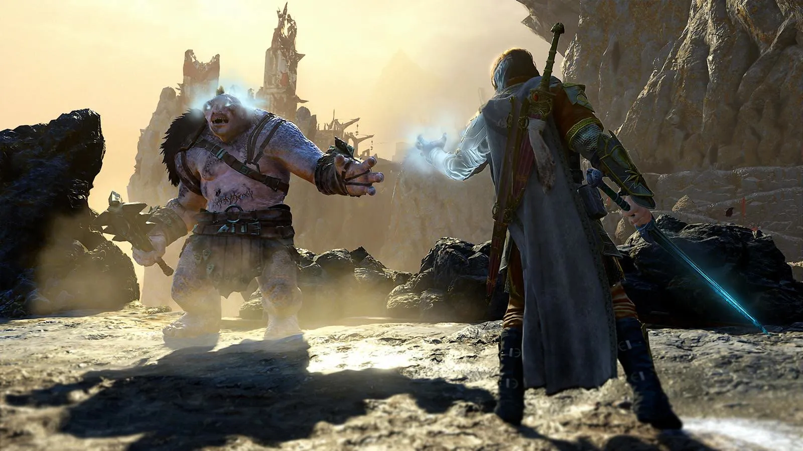 Official promotional still of Talion using spectral Wraith power to dominate a massive Olog-hai on rocky Mordor terrain with a cliffside fortress behind them.